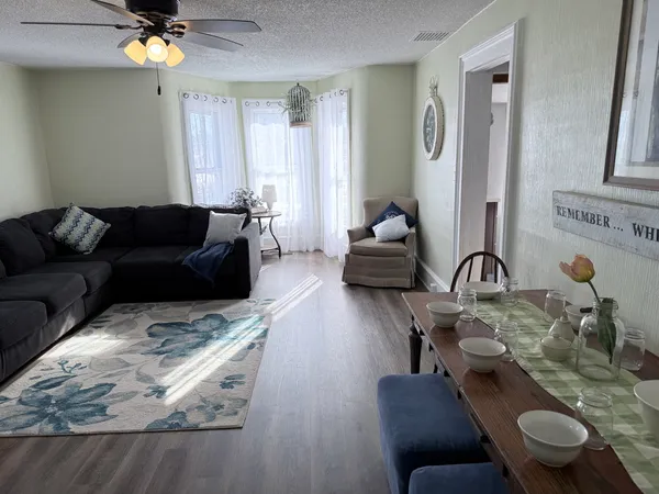 a living room with furniture and a chandelier