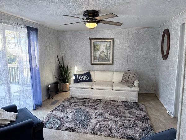a living room with furniture and a rug