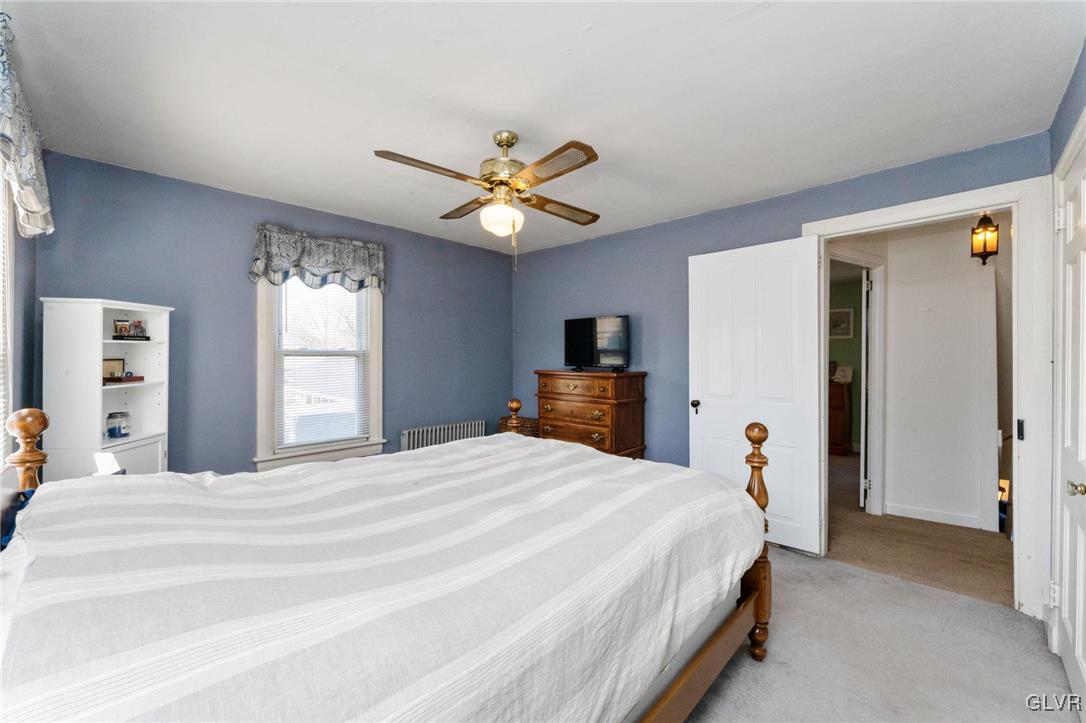 4651 Huckleberry Road Orefield, PA 18069 - Photo 17 of 30 a bedroom with a bed and a chandelier