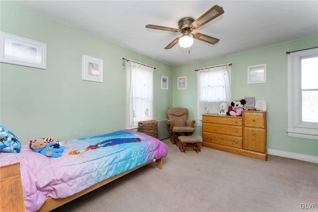 4651 Huckleberry Road Orefield, PA 18069 - Photo 18 of 30 a bedroom with a bed and a chandelier