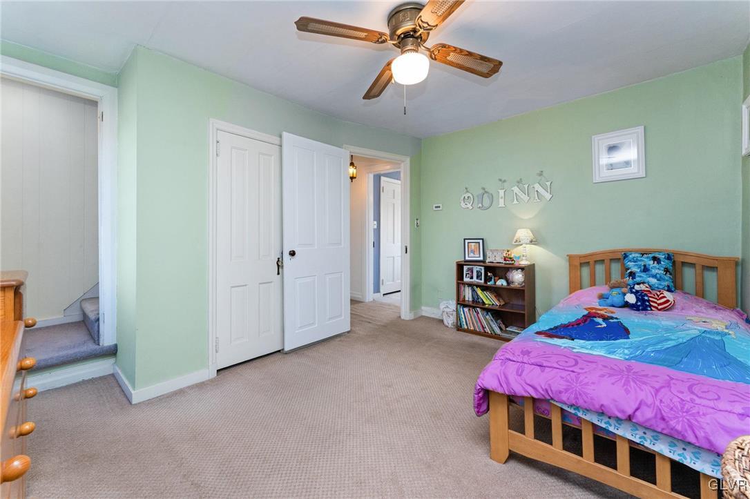 4651 Huckleberry Road Orefield, PA 18069 - Photo 19 of 30 a bedroom with bed and a chandelier