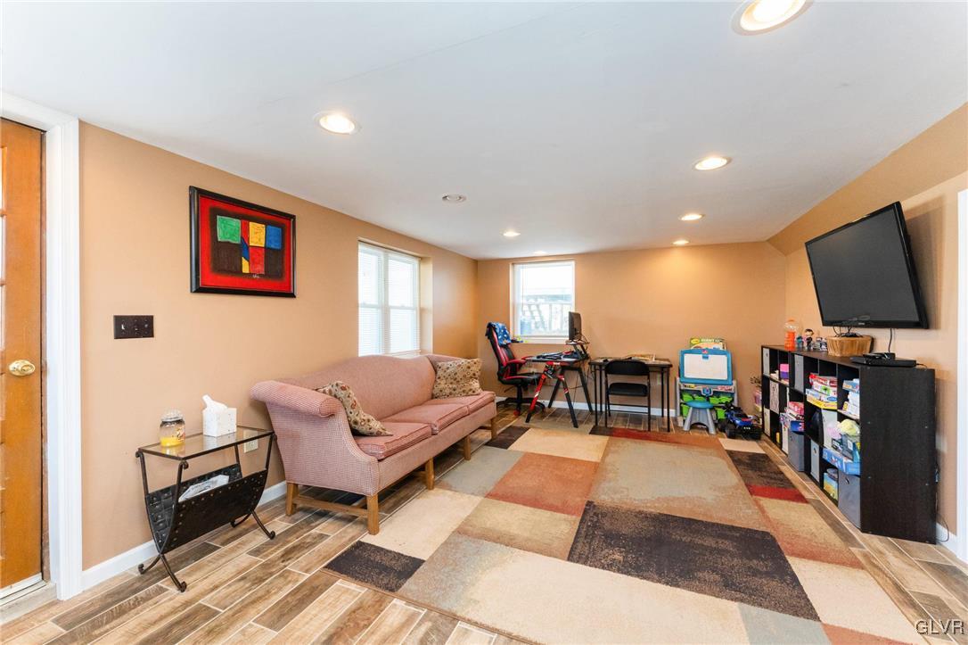 4651 Huckleberry Road Orefield, PA 18069 - Photo 22 of 30 a living room with furniture and a flat screen tv