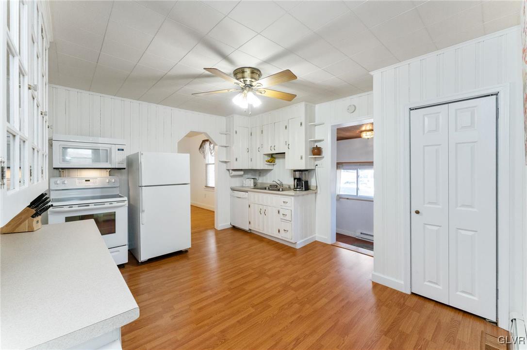 4651 Huckleberry Road Orefield, PA 18069 - Photo 7 of 30 a kitchen with stainless steel appliances a stove top oven a refrigerator cabinets and wooden floor
