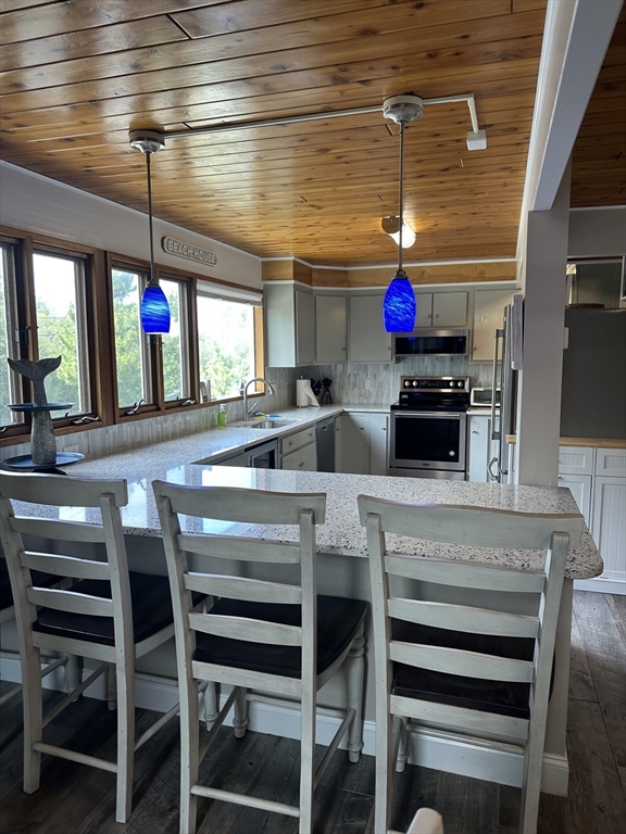 1 Sandy Way Gloucester, MA 01930 - Photo 3 of 14 a kitchen with stainless steel appliances kitchen island granite countertop a stove and cabinets