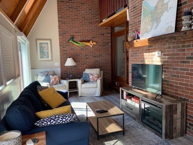 1 Sandy Way Gloucester, MA 01930 - Photo 6 of 14 a living room with furniture a flat screen tv and a fireplace