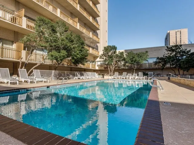 a view of swimming pool with a yard