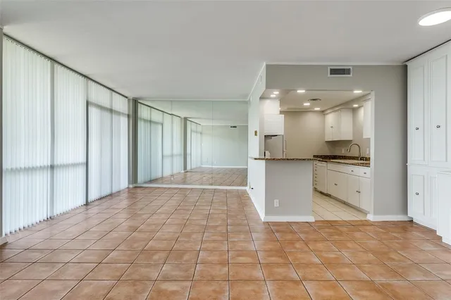a large white bathroom with a granite countertop sink mirror and