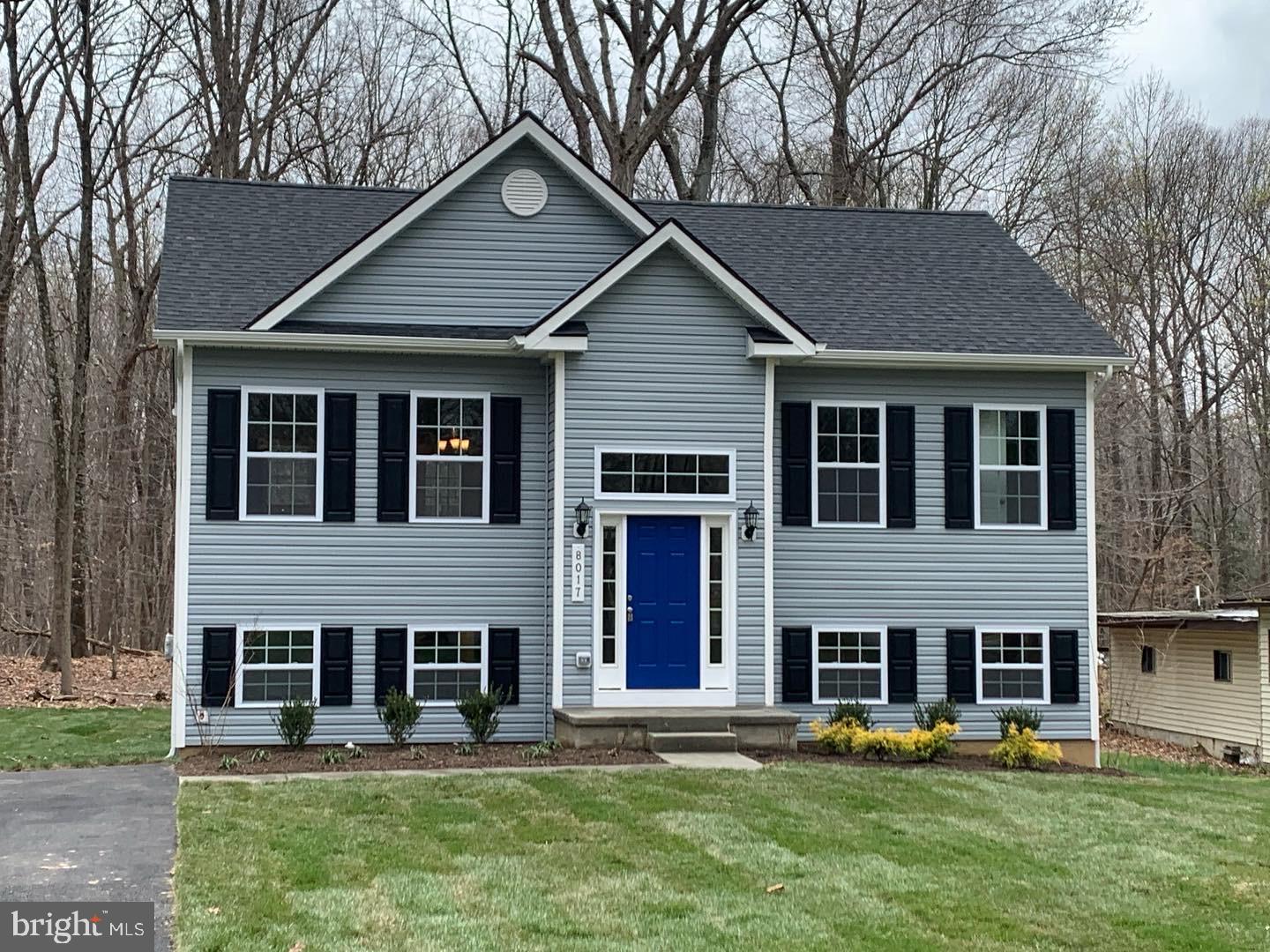8017 Bock Road Fort Washington, MD 20744 - Photo 1 of 1 a view of a yard in front of a house with plants and large tree