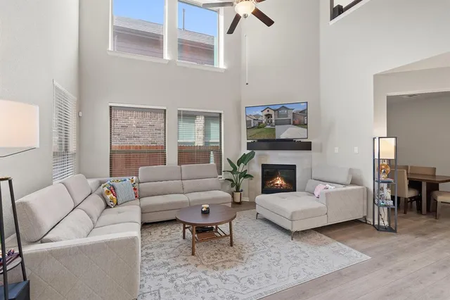a living room with furniture a fireplace and a table