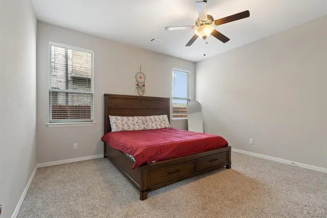 a spacious bedroom with a bed and a chandelier