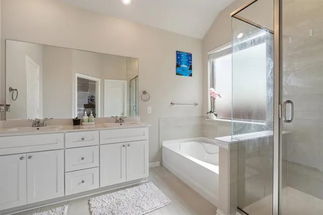 a bathroom with a tub a sink and mirrors