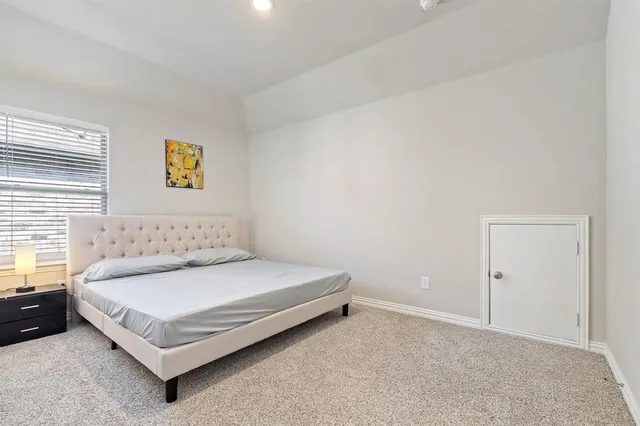 a bedroom with a bed and a couch