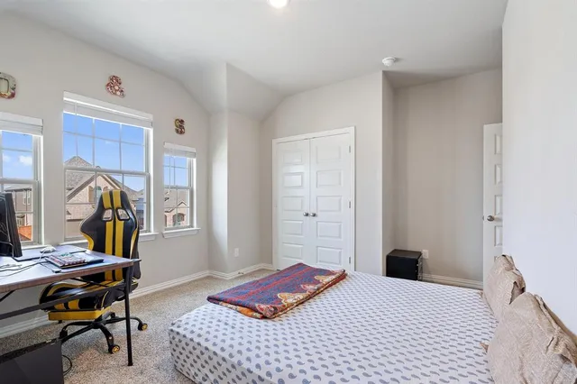 a bedroom with a bed and a desk