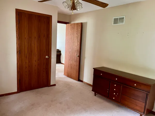 a room with a dresser and a shower