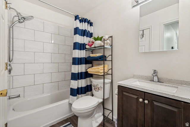 254 North 700 East Santaquin, UT 84655 - Photo 10 of 15 Full bathroom featuring a tub/shower combination with white subway tile surround, a dark wood-finish vanity with an integrated white sink, and a speckled countertop