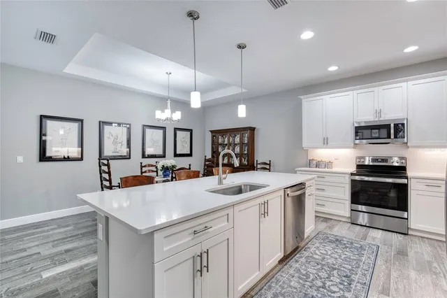 a kitchen with cabinets and stainless steel appliances