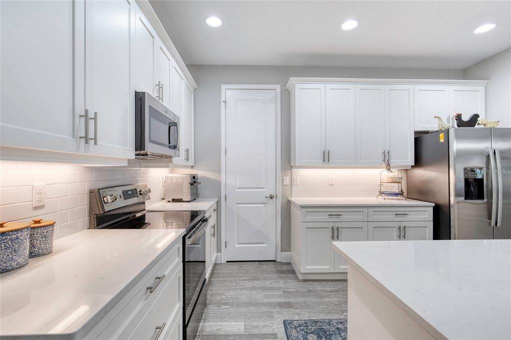 51 Wrendale Loop Ormond Beach, FL 32174 - Photo 19 of 58 a kitchen with cabinets and stainless steel appliances