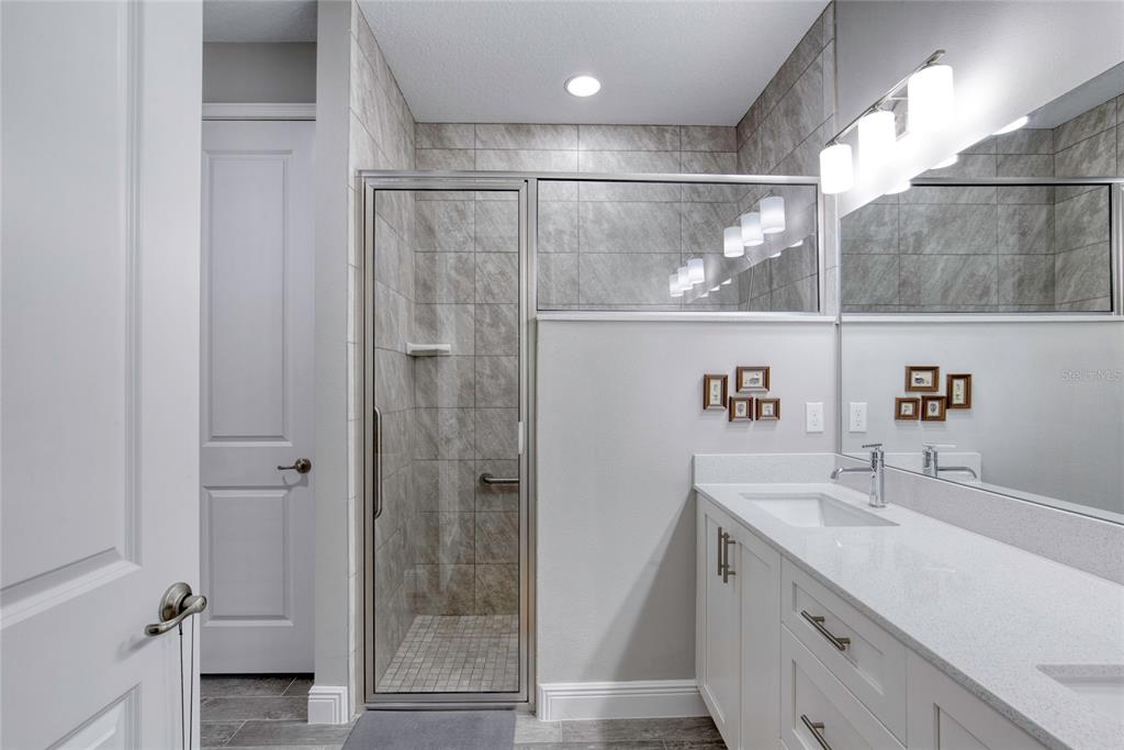 51 Wrendale Loop Ormond Beach, FL 32174 - Photo 25 of 58 a bathroom with a shower sink and mirror