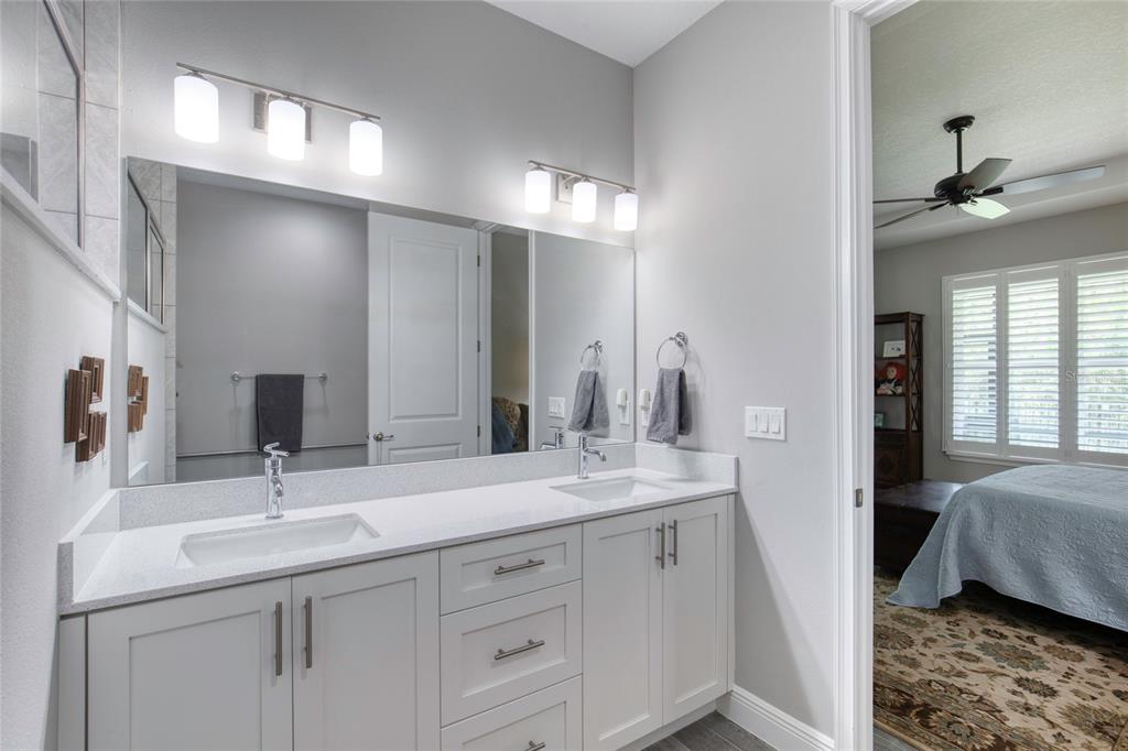 51 Wrendale Loop Ormond Beach, FL 32174 - Photo 26 of 58 a en suite bathroom with double sink and a mirror