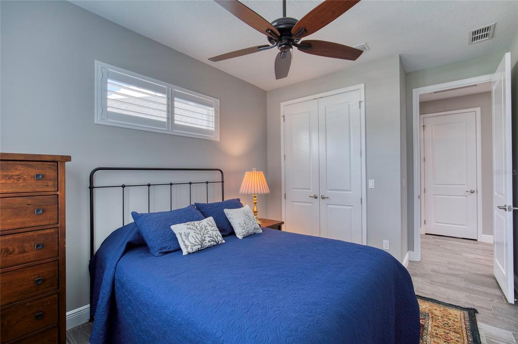 51 Wrendale Loop Ormond Beach, FL 32174 - Photo 29 of 58 a bedroom with a bed and a chandelier