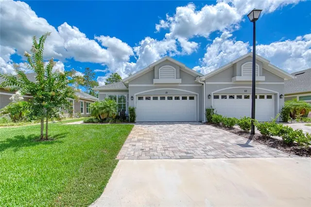 a front view of a house with a garden and entryway