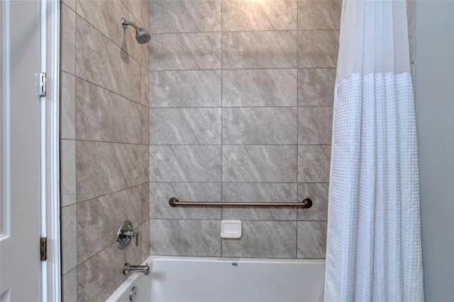 a view of a porch with furniture and wooden floor