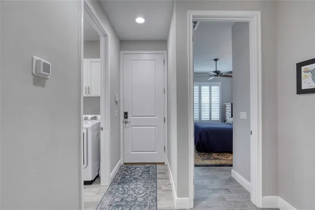 a view of entryway and hall with wooden floor