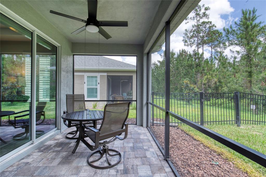 51 Wrendale Loop Ormond Beach, FL 32174 - Photo 35 of 58 a view of a porch with chairs and backyard