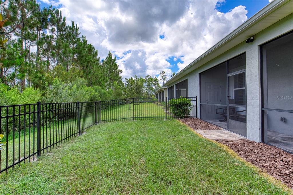 51 Wrendale Loop Ormond Beach, FL 32174 - Photo 40 of 58 a view of a backyard with a garden