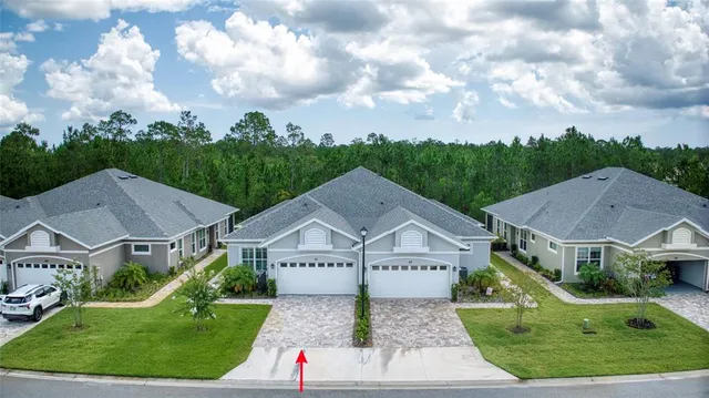 a aerial view of a house with a garden and lake view