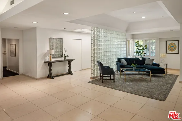 a living room with furniture a window and a table