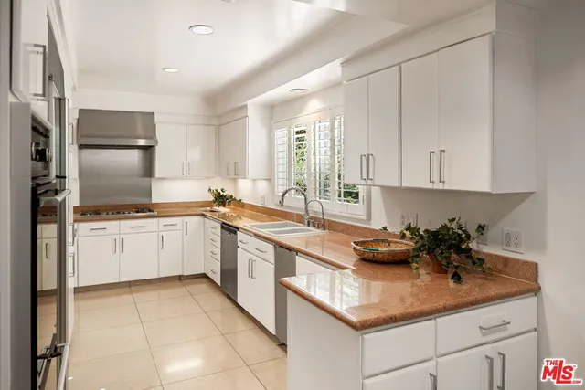 a kitchen with a sink cabinets and window