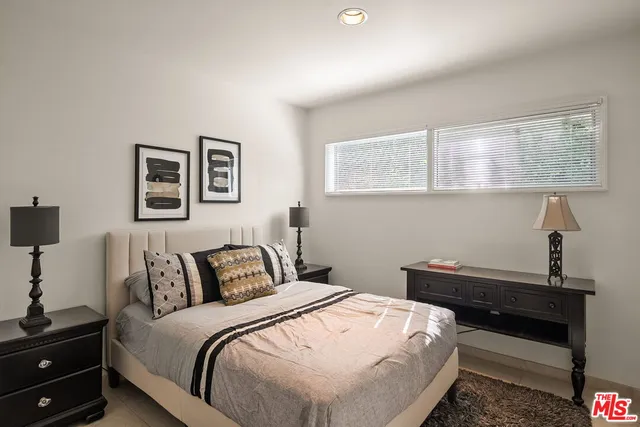 a bedroom with a bed and a night stand