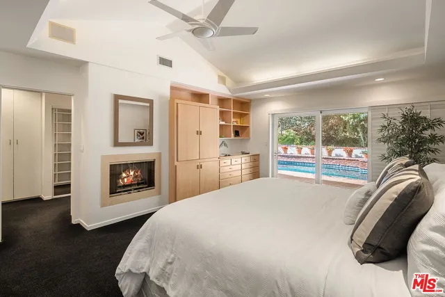 a spacious bedroom with a bed and a fireplace