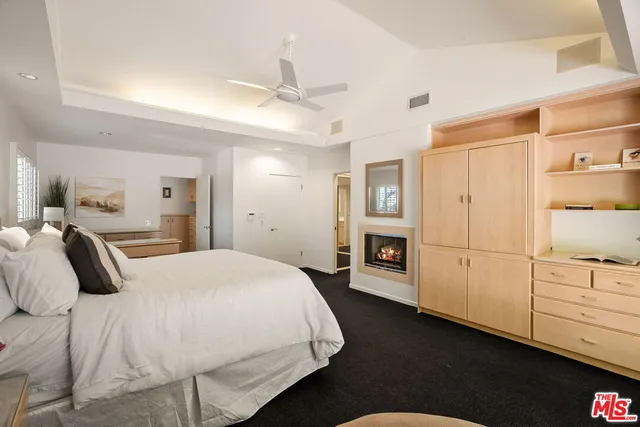a bed room with a bed and a ceiling fan