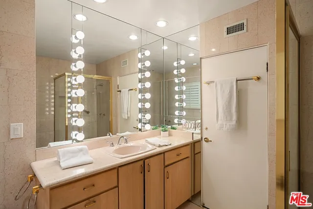 a bathroom with a sink double vanity and a mirror