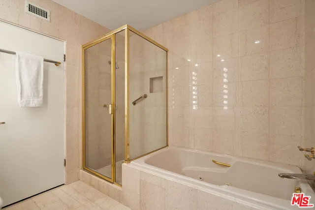 a bathroom with a bathtub and a shower