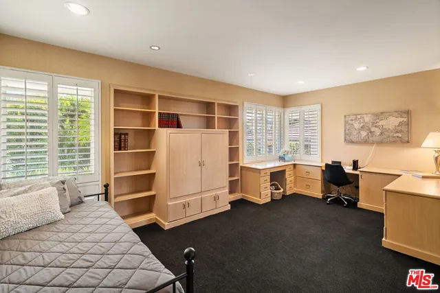 a bedroom with furniture and windows