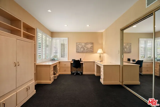 a bedroom with a bed and a refrigerator