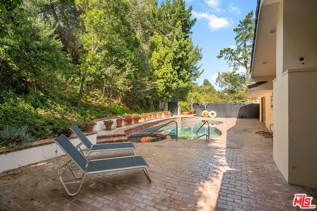 a view of backyard of the house with seating space