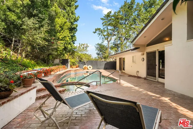 a view of backyard of house with seating space