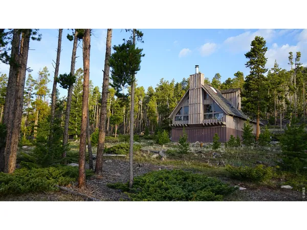 a balcony with a view of outdoor space and trees
