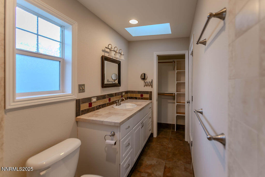 43 Ardmore Drive Reno, NV 89509 - Photo 17 of 28 a bathroom with a sink a toilet and a mirror