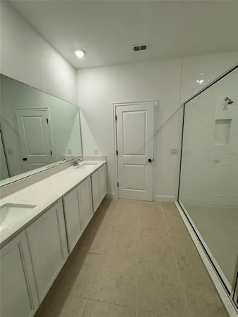 a view of a bathroom with double sink and a mirror
