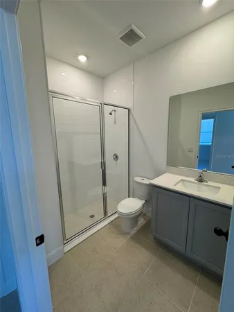 a bathroom with a double vanity sink toilet and shower