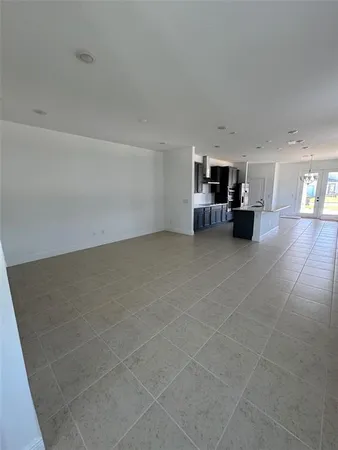 a view of a livingroom and a kitchen with furniture and a fireplace
