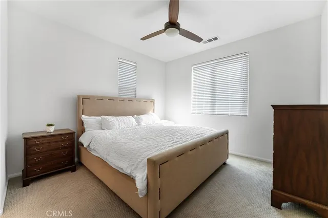 a bedroom with a bed and a ceiling fan