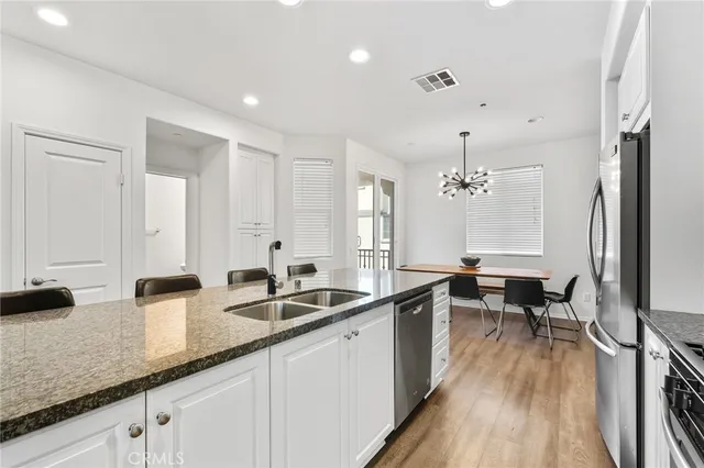 a large white kitchen with a large window