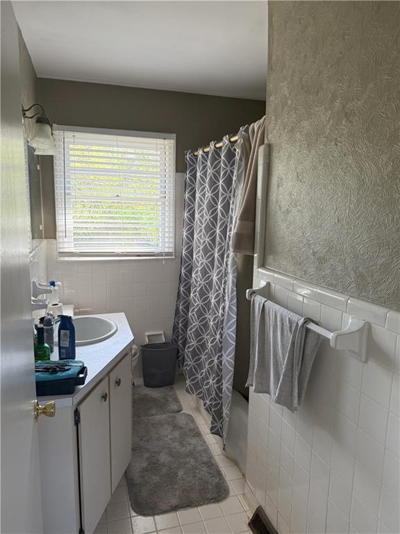 3674 Canton Road Marietta, GA 30066 - Photo 13 of 20 a bathroom with a sink a toilet and shower