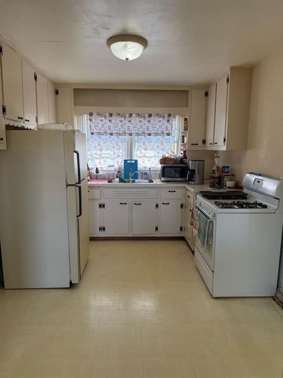 3674 Canton Road Marietta, GA 30066 - Photo 15 of 20 a kitchen with stainless steel appliances a stove a refrigerator white cabinets and a refrigerator